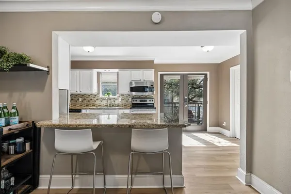 a kitchen with stainless steel appliances granite countertop a stove and a sink