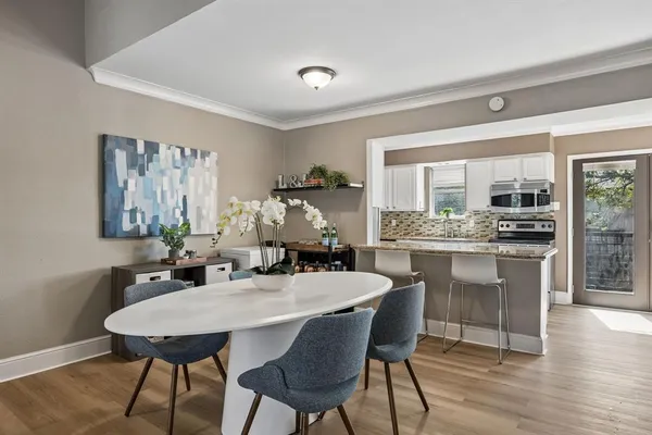 a dining room with furniture and wooden floor