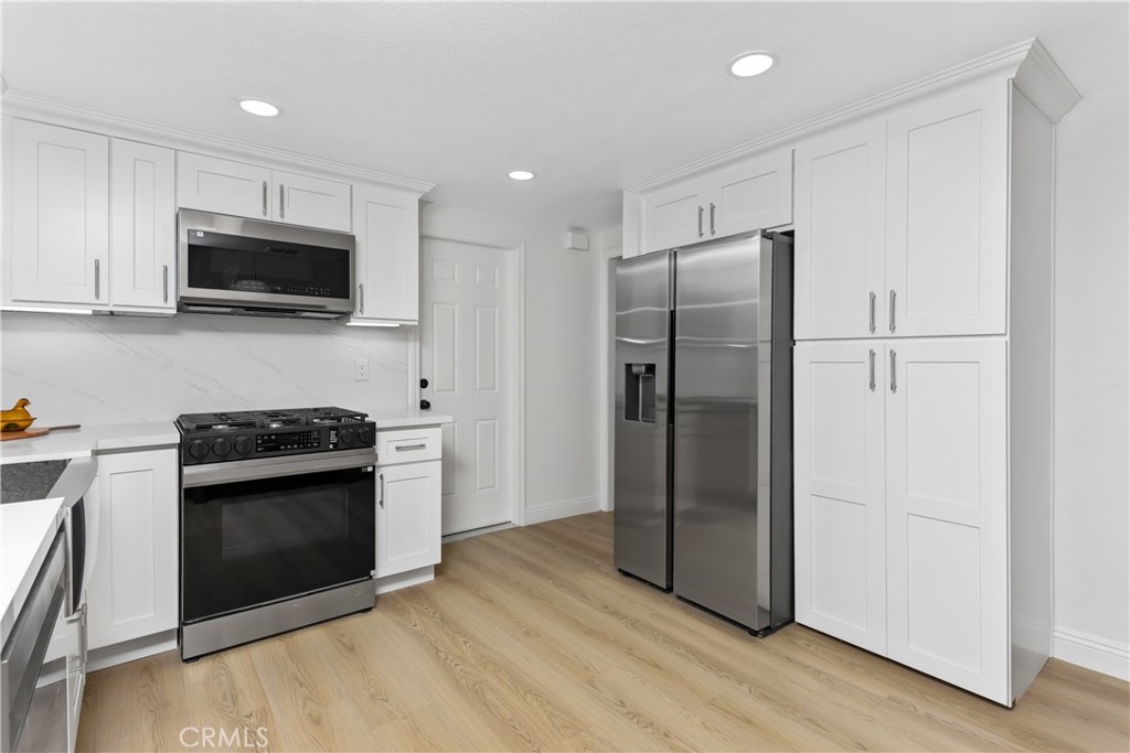 304 North Dearborn Street Redlands, CA 92374 - Photo 15 of 39 a kitchen with stainless steel appliances granite countertop a stove a refrigerator and a microwave