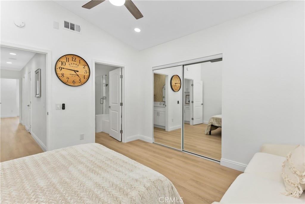 304 North Dearborn Street Redlands, CA 92374 - Photo 23 of 39 a spacious bedroom with a bed and a chandelier