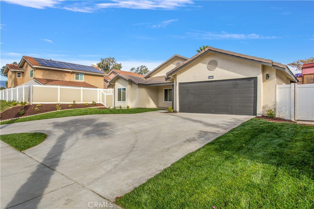 304 North Dearborn Street Redlands, CA 92374 - Photo 5 of 39 a front view of a house with a yard and garage