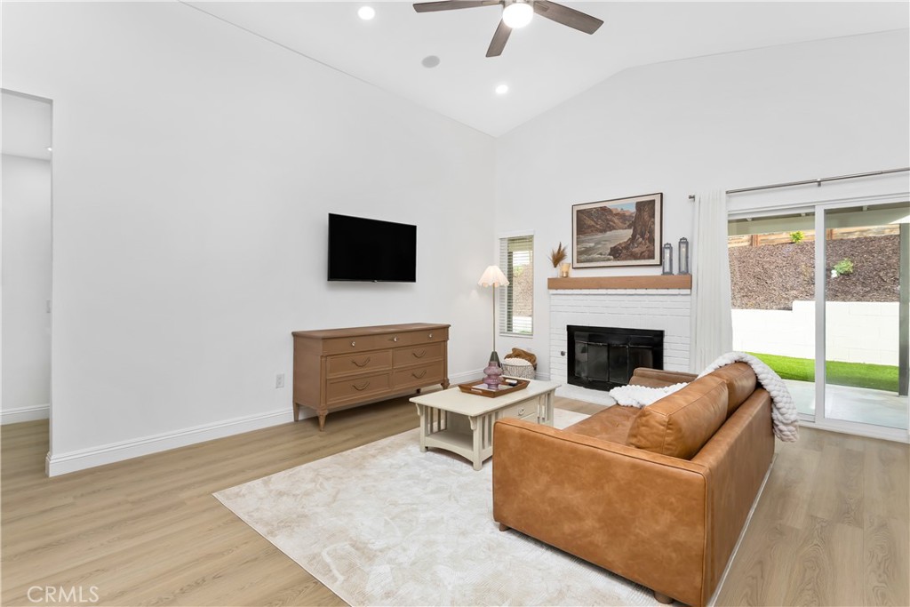 304 North Dearborn Street Redlands, CA 92374 - Photo 8 of 39 a living room with furniture a fireplace and a flat screen tv