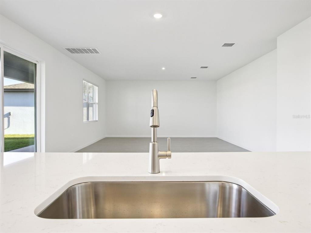 13311 Shellmore Avenue Palmetto, FL 34221 - Photo 14 of 46 a view of a kitchen with a sink a window and an entryway