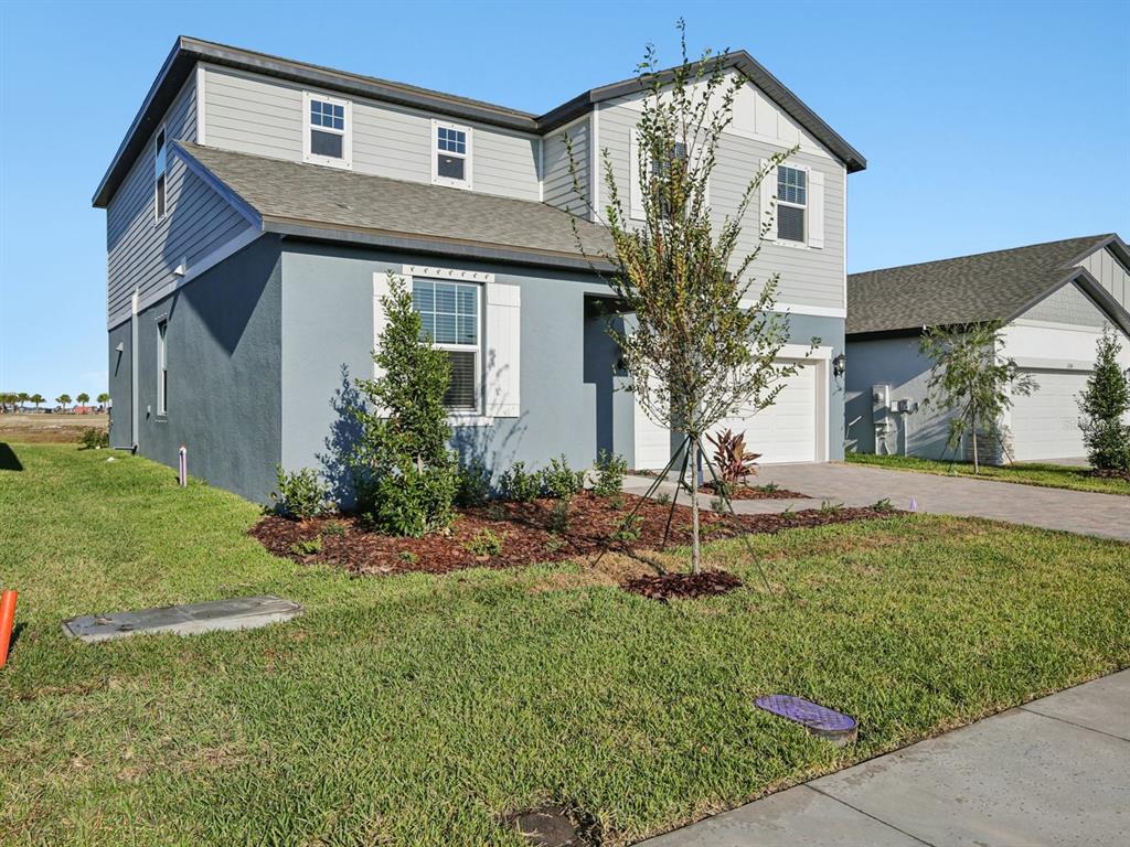 13311 Shellmore Avenue Palmetto, FL 34221 - Photo 3 of 46 a front view of a house with a yard