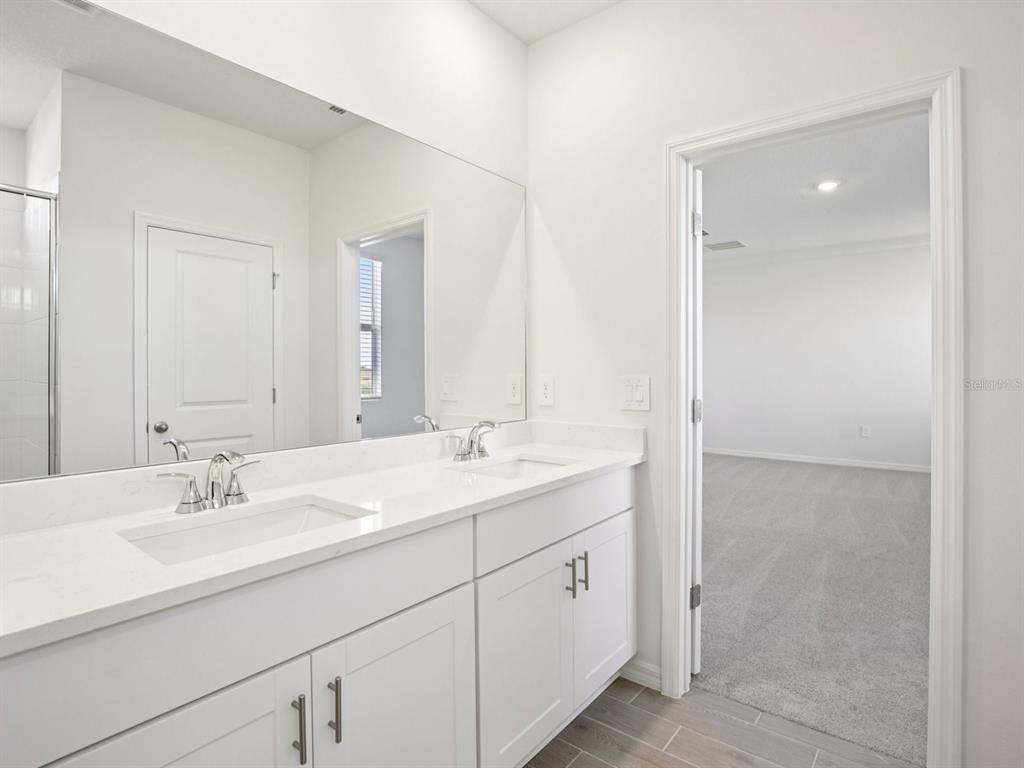 13311 Shellmore Avenue Palmetto, FL 34221 - Photo 31 of 46 a bathroom with a sink and a mirror