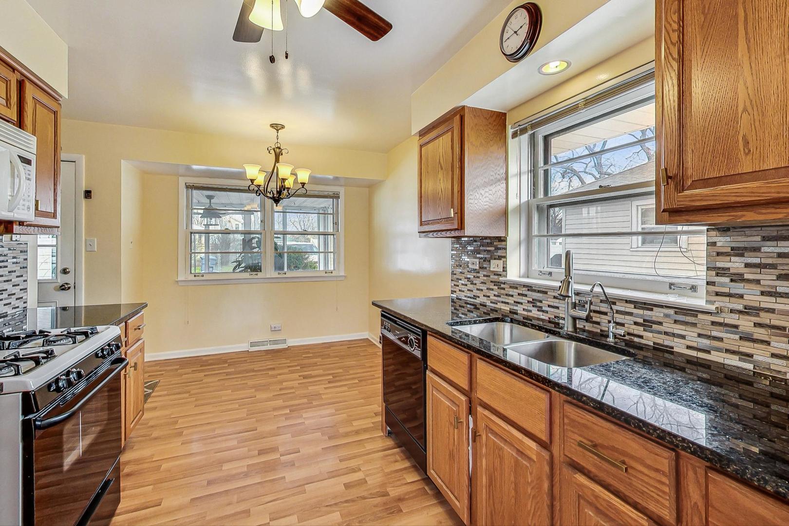 225 West Butterfield Road Elmhurst, IL 60126 - Photo 8 of 29 a kitchen with stainless steel appliances granite countertop a sink stove and refrigerator