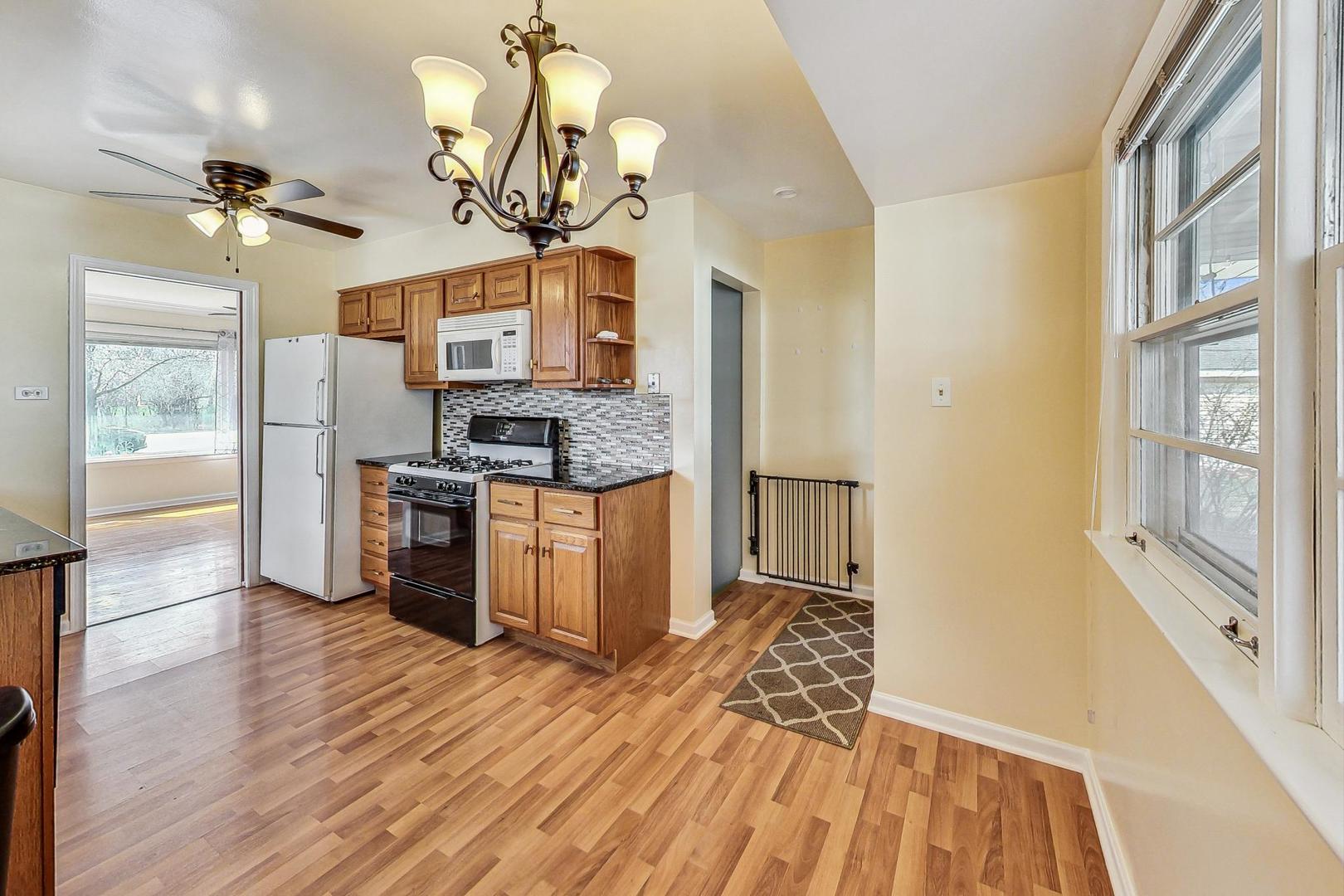 225 West Butterfield Road Elmhurst, IL 60126 - Photo 9 of 29 a view of a kitchen center island wooden floor and stainless steel appliances