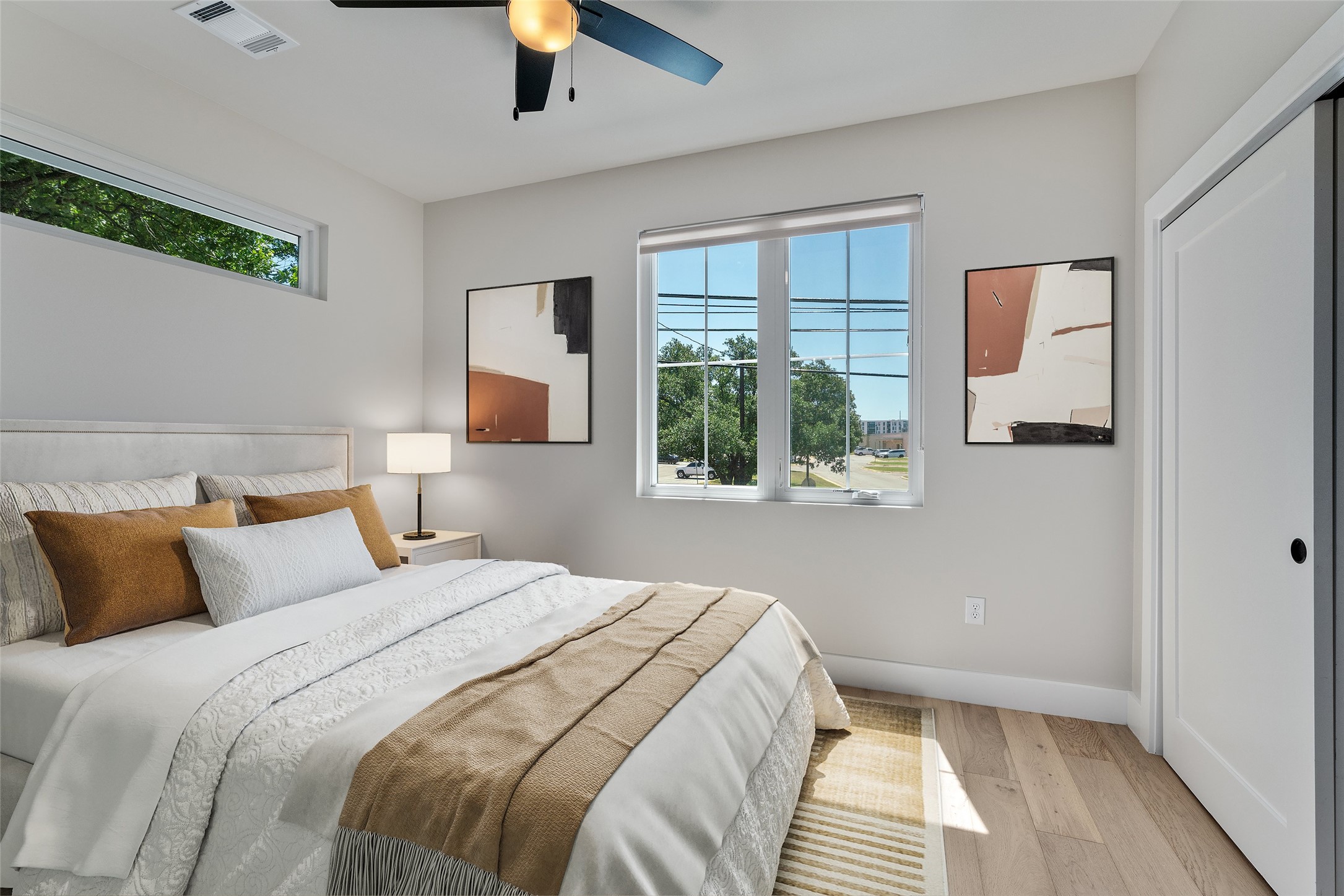 5200 Grover Avenue Austin, TX 78756 - Photo 21 of 32 Virtually Staged. Spacious secondary bedroom with full bathroom. Featuring wood flooring, a contemporary ceiling fan, and multiple windows.