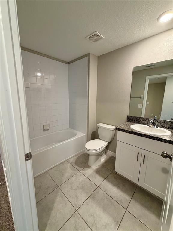 11826 Dumaine Valley Road Riverview, FL 33579 - Photo 23 of 54 a bathroom with a double vanity sink a toilet a mirror and bathtub