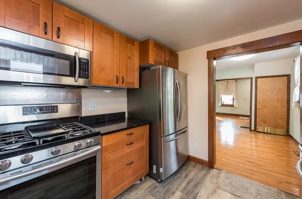 a kitchen with stainless steel appliances granite countertop a stove and a refrigerator