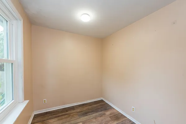 a view of small space with wooden floor and windows
