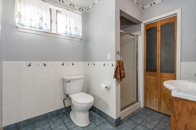 a white toilet sitting next to a bathroom sink