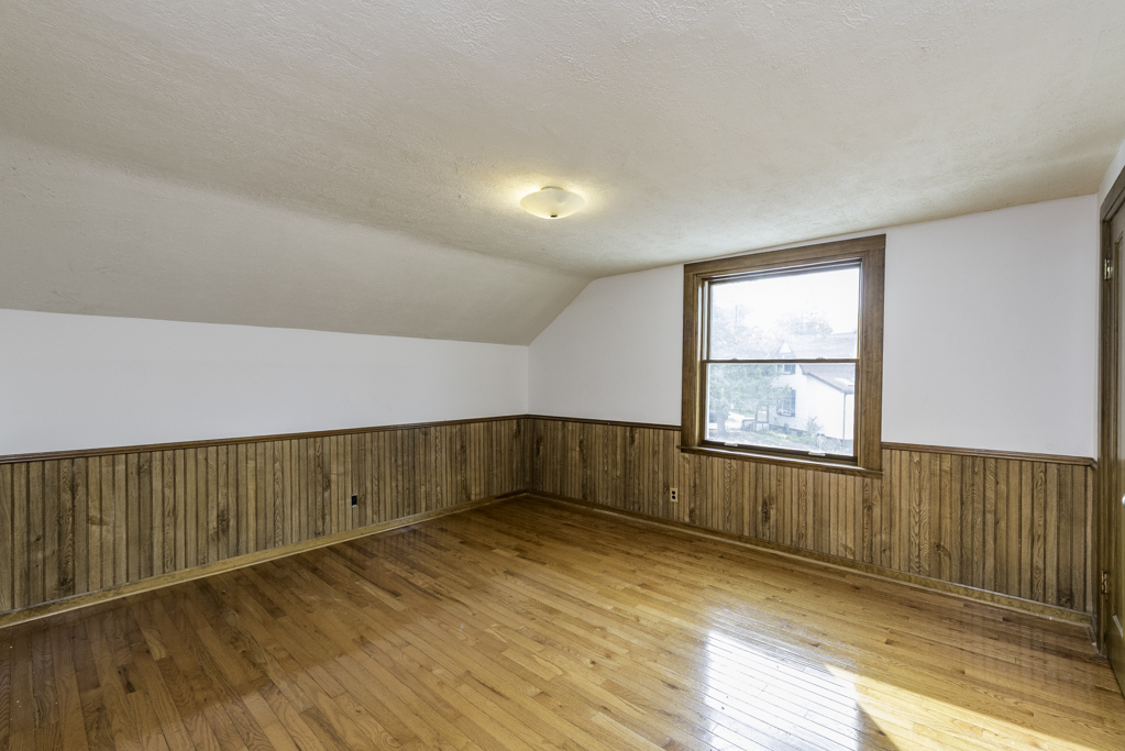 511 Chestnut Street Waukegan, IL 60085 - Photo 17 of 25 an empty room with wooden floor and windows