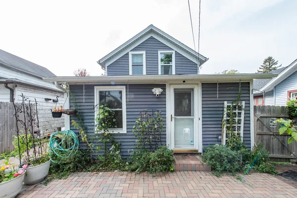 a front view of a house with potted plants