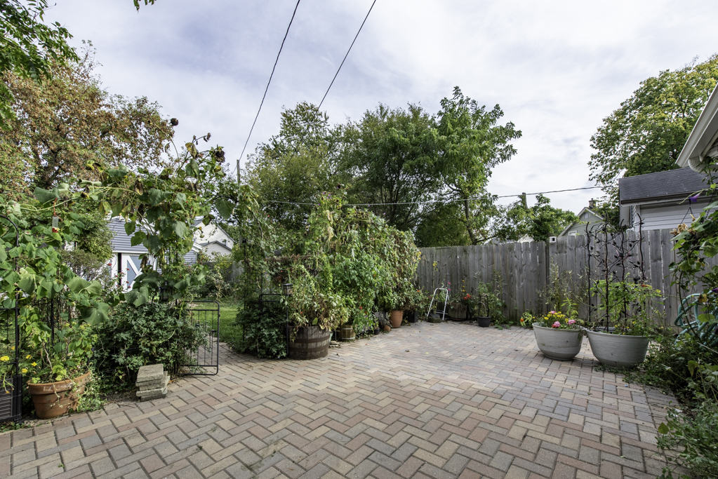511 Chestnut Street Waukegan, IL 60085 - Photo 23 of 25 a view of a backyard with potted plants and a fountain