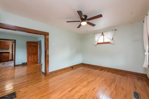 a view of a big room with wooden floor closet and windows