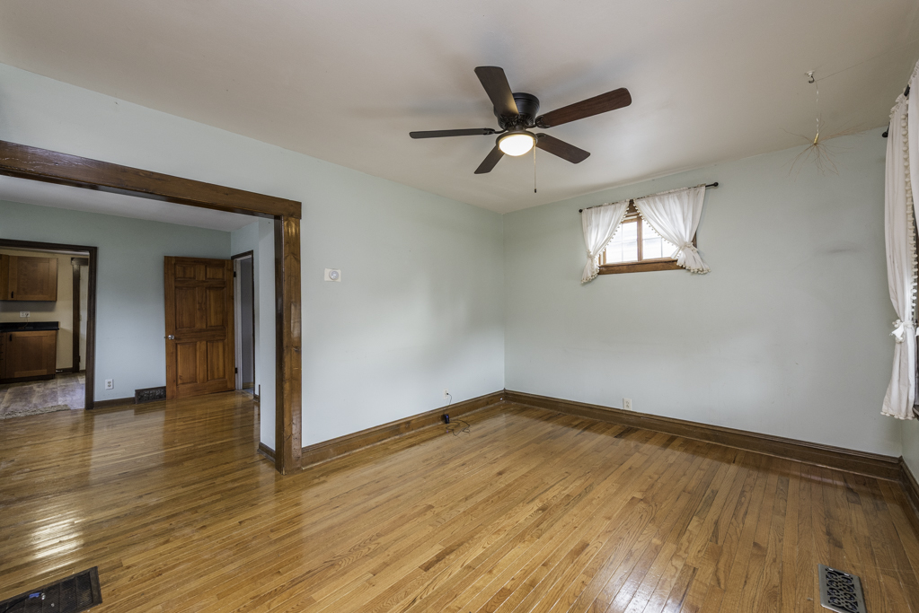 511 Chestnut Street Waukegan, IL 60085 - Photo 3 of 25 a view of a big room with wooden floor closet and windows