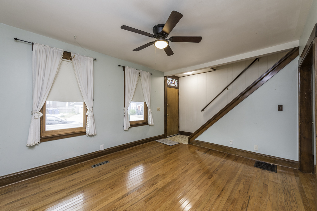 511 Chestnut Street Waukegan, IL 60085 - Photo 5 of 25 a view of an empty room with wooden floor and a window