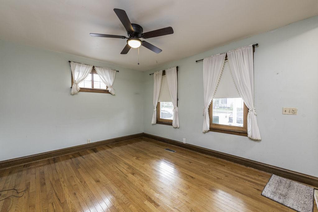 511 Chestnut Street Waukegan, IL 60085 - Photo 6 of 25 wooden floor in an empty room with a window