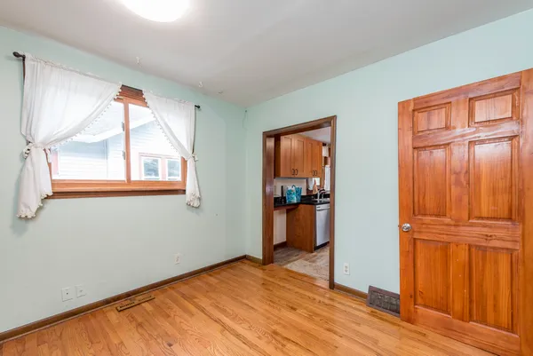 wooden floor in an empty room and a window