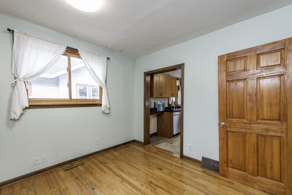 511 Chestnut Street Waukegan, IL 60085 - Photo 7 of 25 wooden floor in an empty room and a window