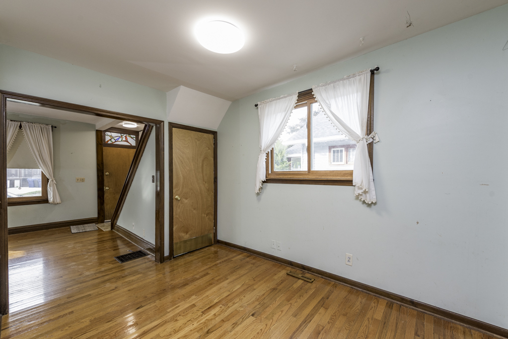 511 Chestnut Street Waukegan, IL 60085 - Photo 8 of 25 wooden floor in an empty room with a window