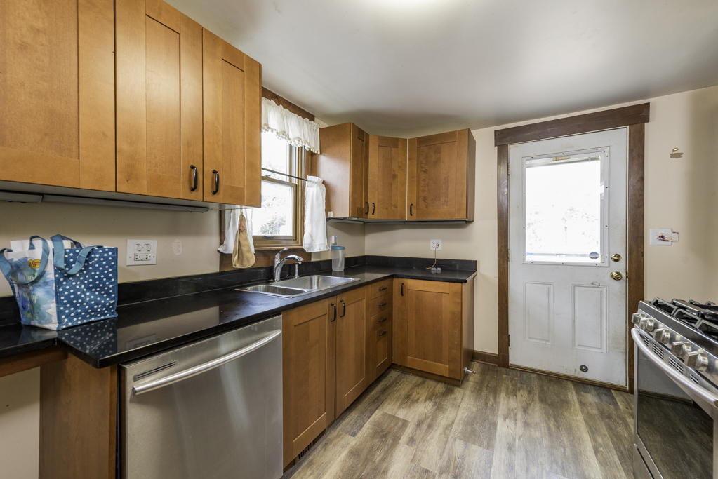 511 Chestnut Street Waukegan, IL 60085 - Photo 10 of 25 a kitchen with granite countertop a sink a stove and cabinets