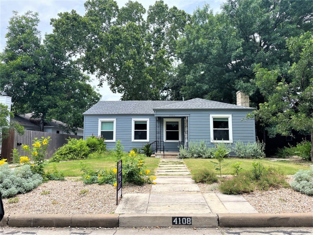 a front view of house with yard and trees