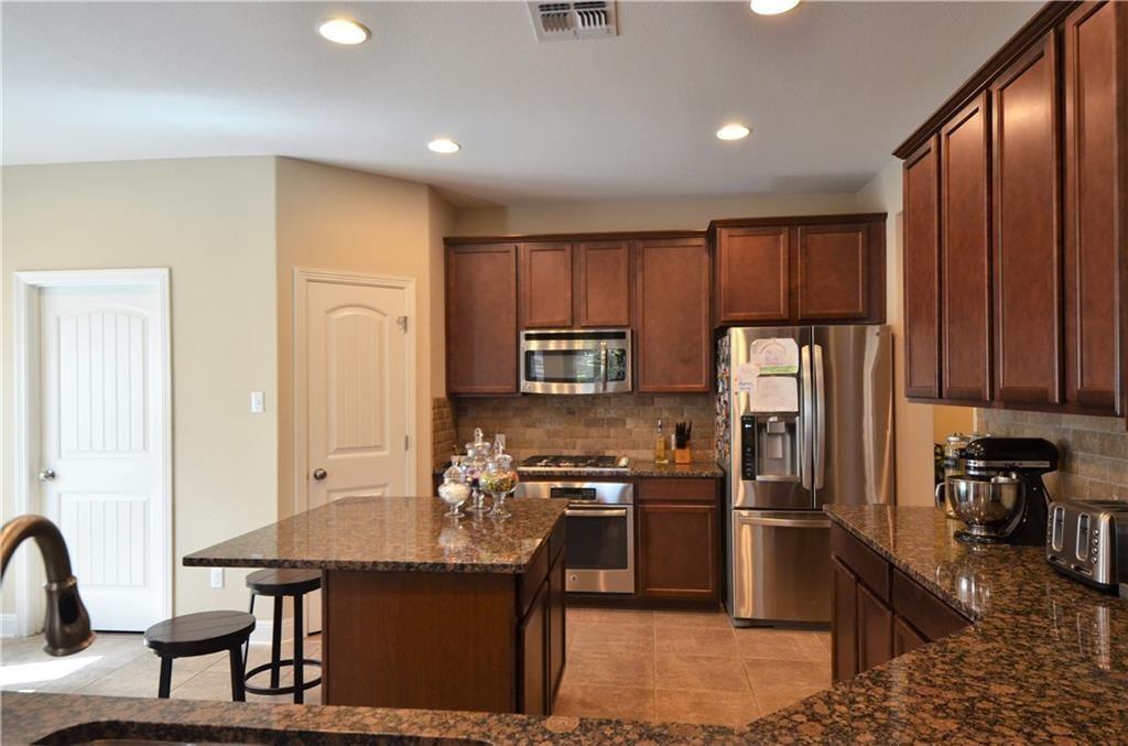 5629 Rio Chama Cove Austin, TX 78738 - Photo 9 of 34 A well-appointed kitchen features rich cabinetry, abundant counter space, and modern appliances.