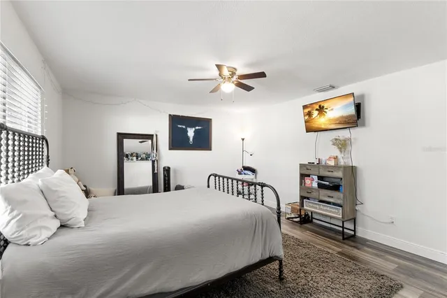 a bedroom with a bed and a tv