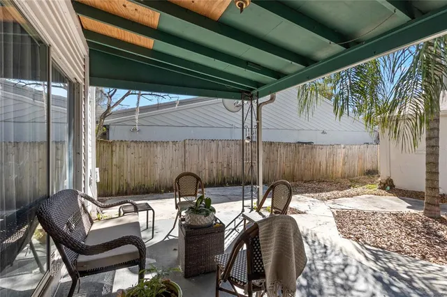 a view of a patio with table and chairs with wooden floor