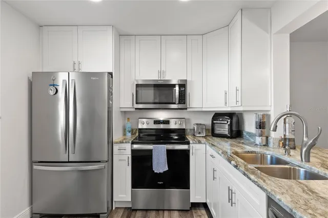 a kitchen with a refrigerator stove and sink