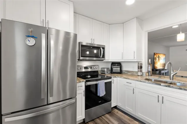 a kitchen with a refrigerator stove and sink