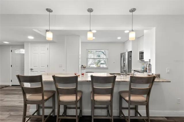 a dining room that has a dining table chairs and a chandelier