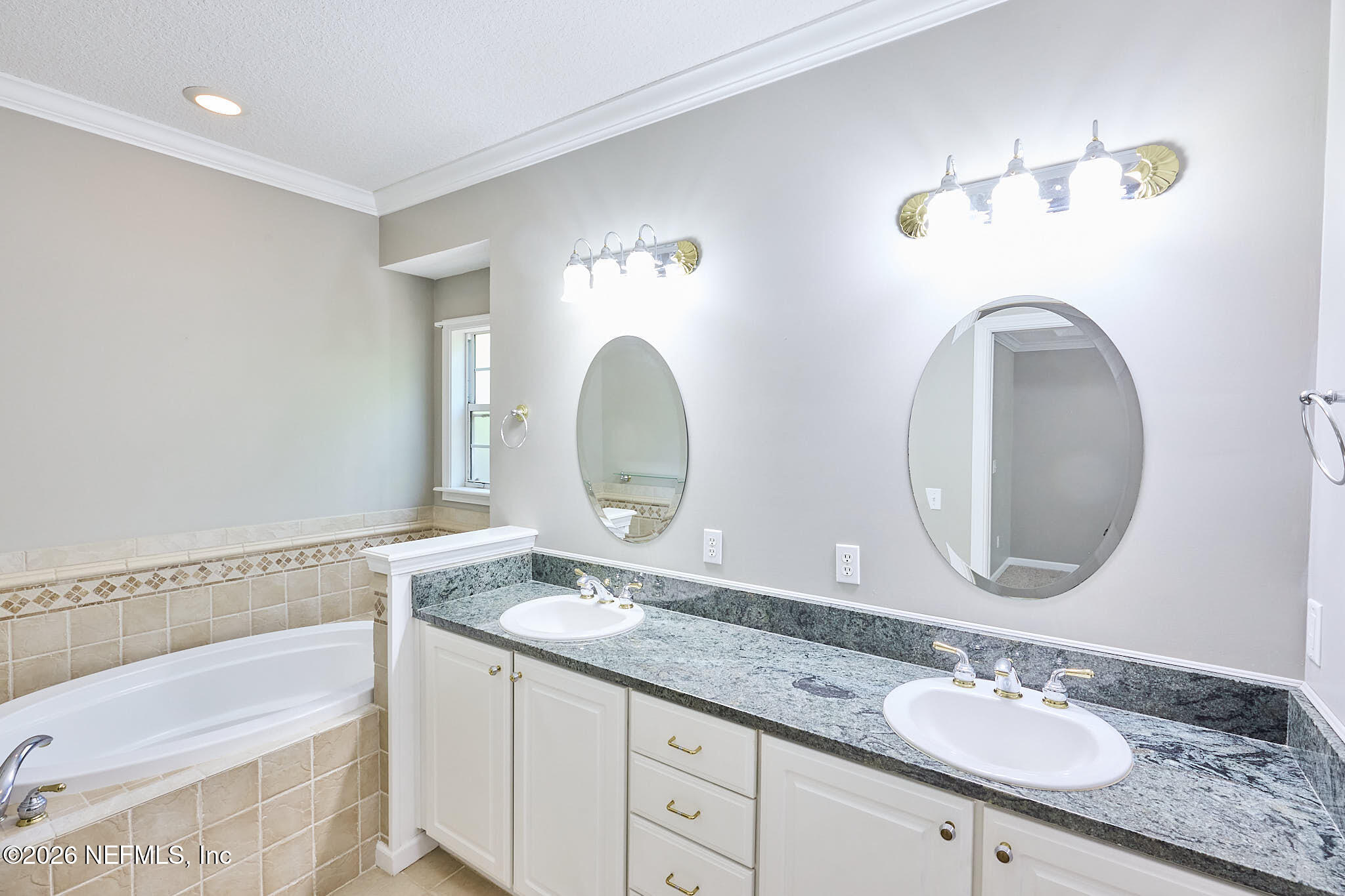 85404 Burmeister Road Fernandina Beach, FL 32034 - Photo 41 of 53 a bathroom with a granite countertop double vanity sink and a mirror