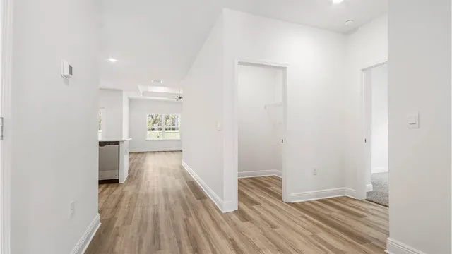 a view of hallway with wooden floor