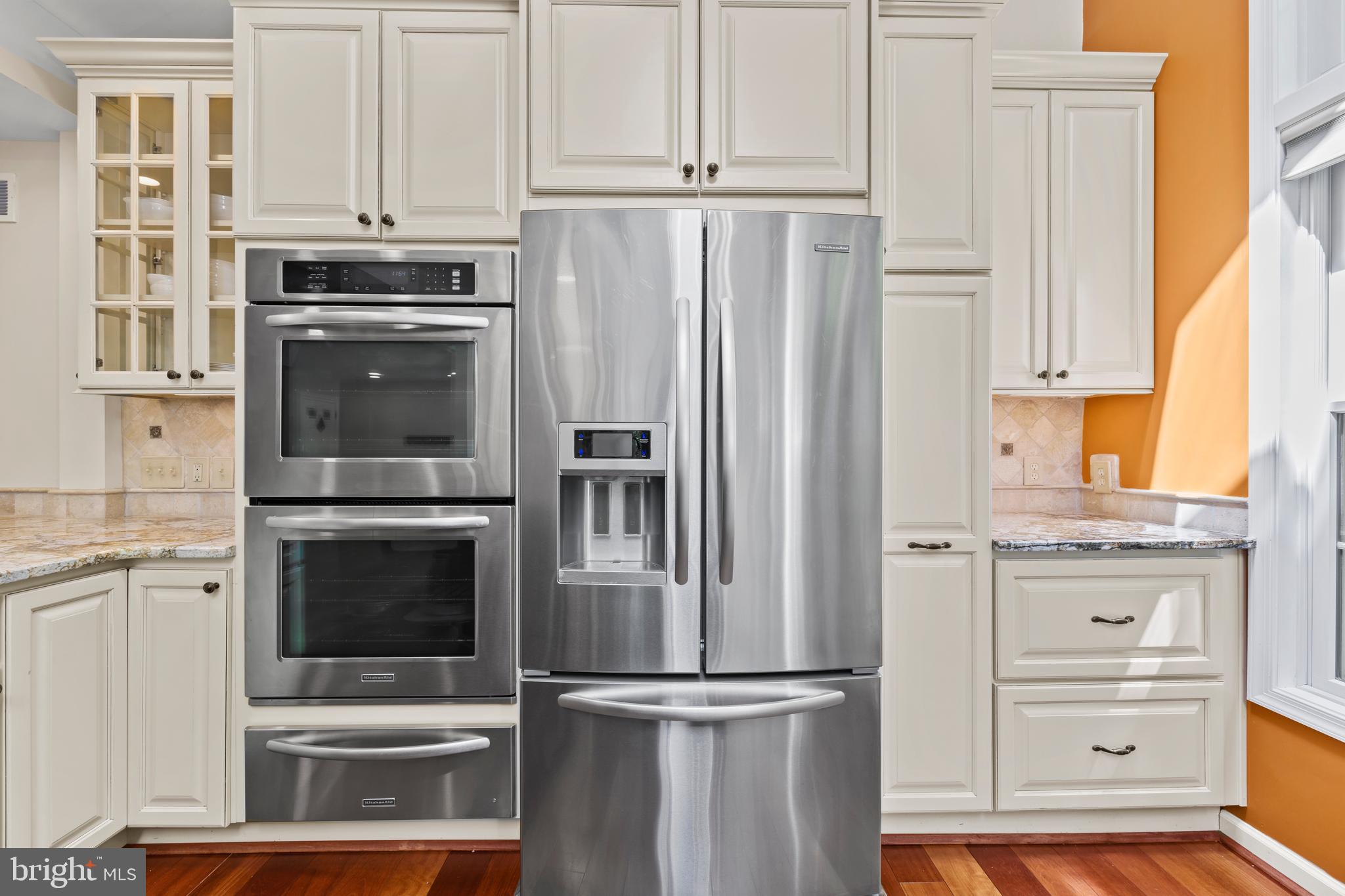 11019 Ring Road Reston, VA 20190 - Photo 25 of 78 a kitchen with granite countertop a refrigerator stove and cabinets