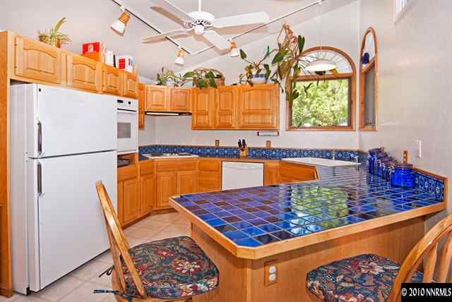 3085 Heatheridge Lane Reno, NV 89509 - Photo 5 of 12 a kitchen with stainless steel appliances granite countertop a sink dishwasher a refrigerator and a stove
