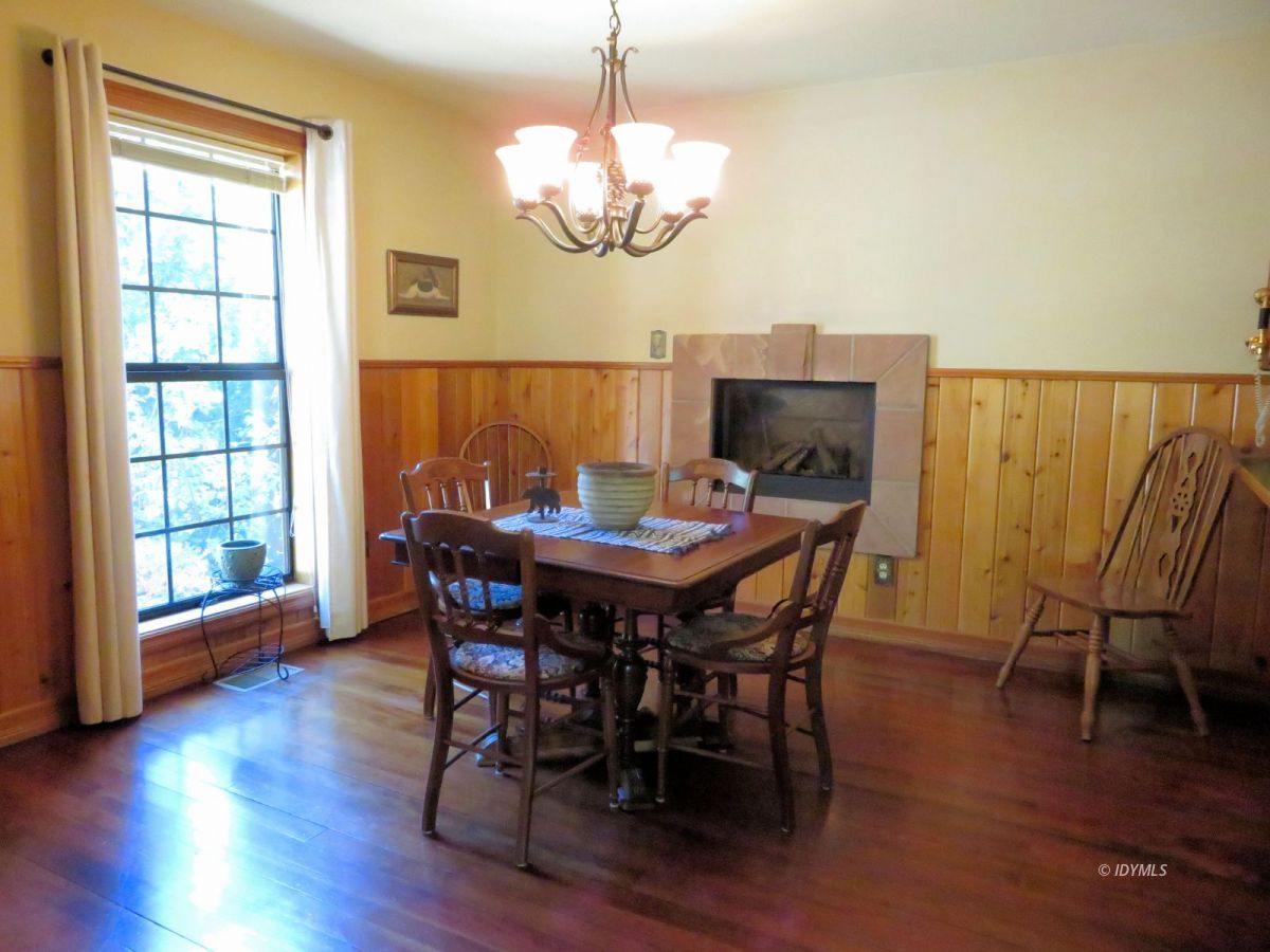 25553 Glen Rd Road Idyllwild, CA 92549 - Photo 7 of 20 a view of a dining room with furniture wooden floor and chandelier