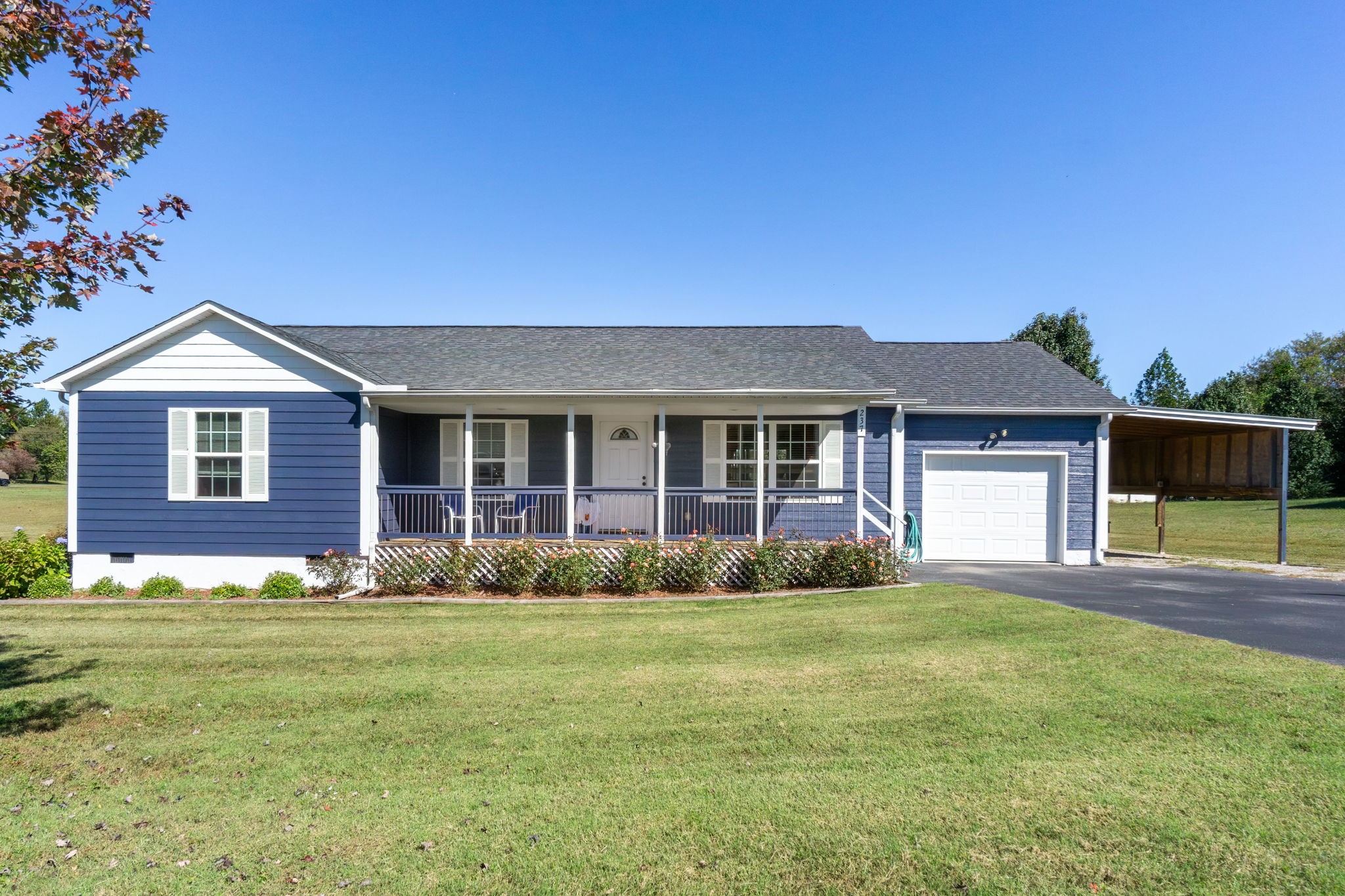a front view of a house with a garden and yard