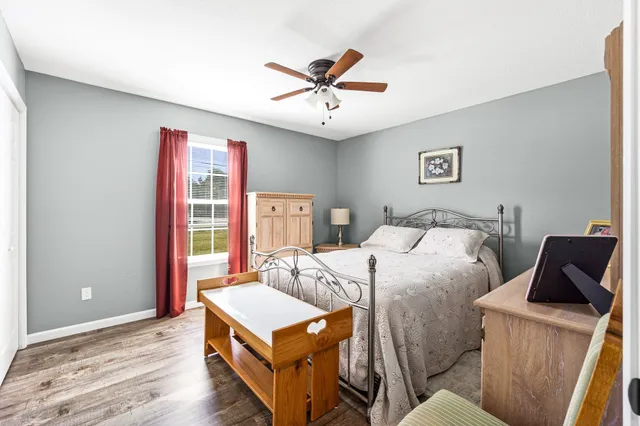 a bedroom with a large bed and a chandelier