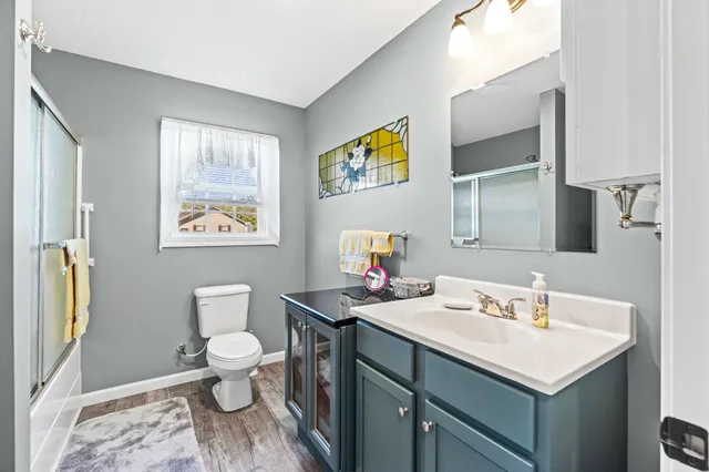 a bathroom with a glass shower door