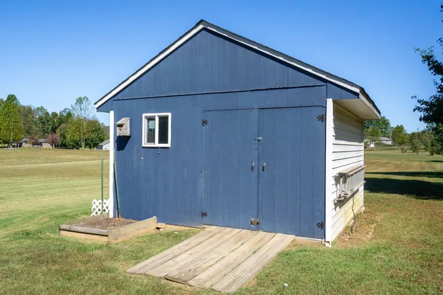 a view of a house with a yard and furniture