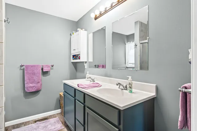 a bathroom with a granite countertop shower and a toilet