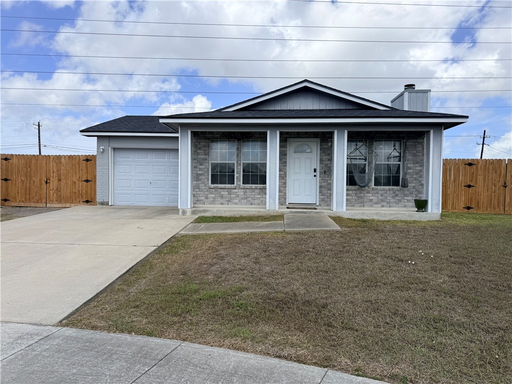 a front view of a house with a garden and garage