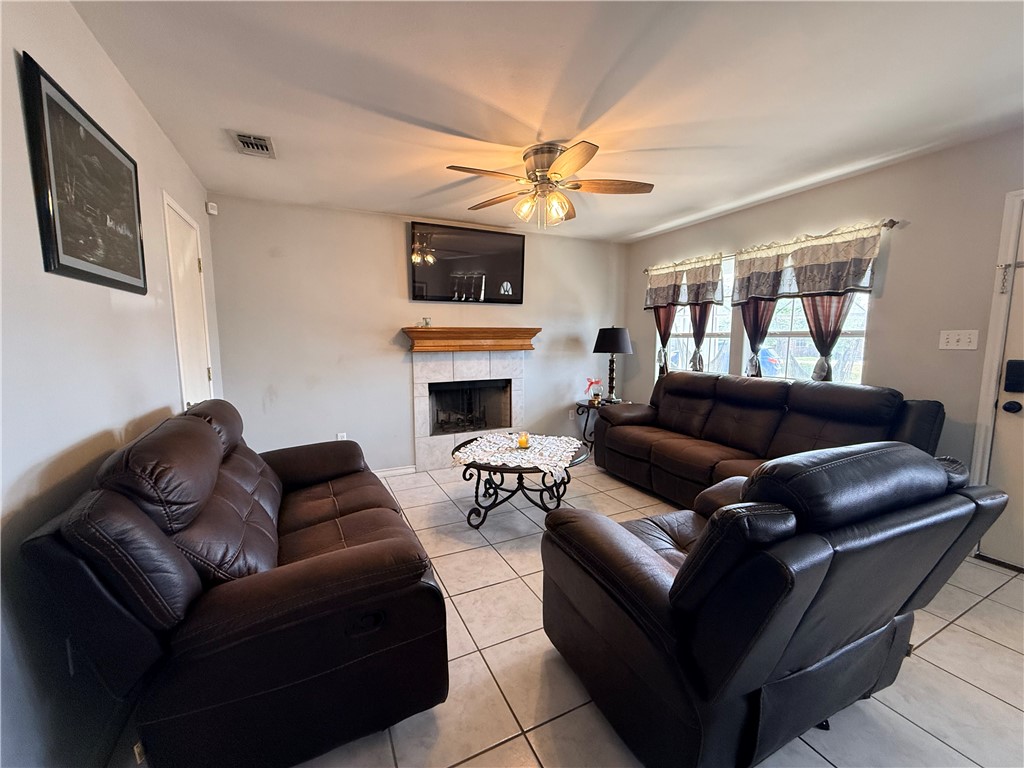 1938 El Monte Street Corpus Christi, TX 78417 - Photo 3 of 9 a living room with furniture ceiling fan and a rug