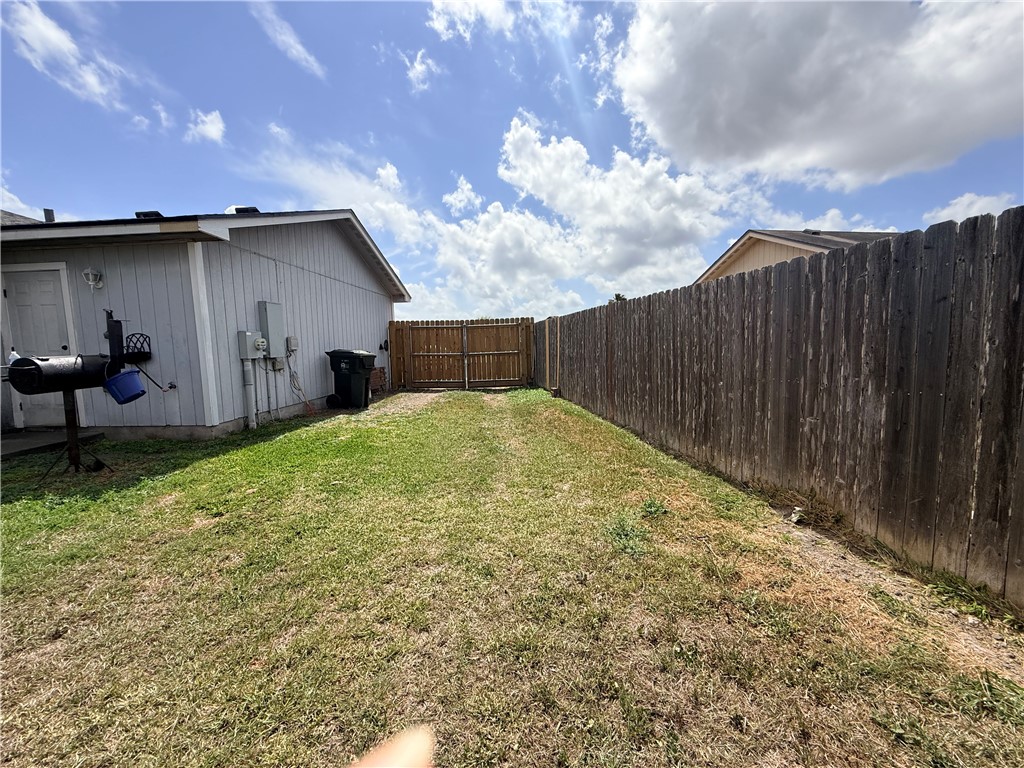 1938 El Monte Street Corpus Christi, TX 78417 - Photo 9 of 9 a view of backyard with barbeque grill potted plants and wooden fence