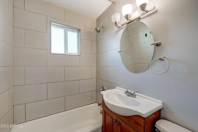 a bathroom with a sink a mirror and a toilet