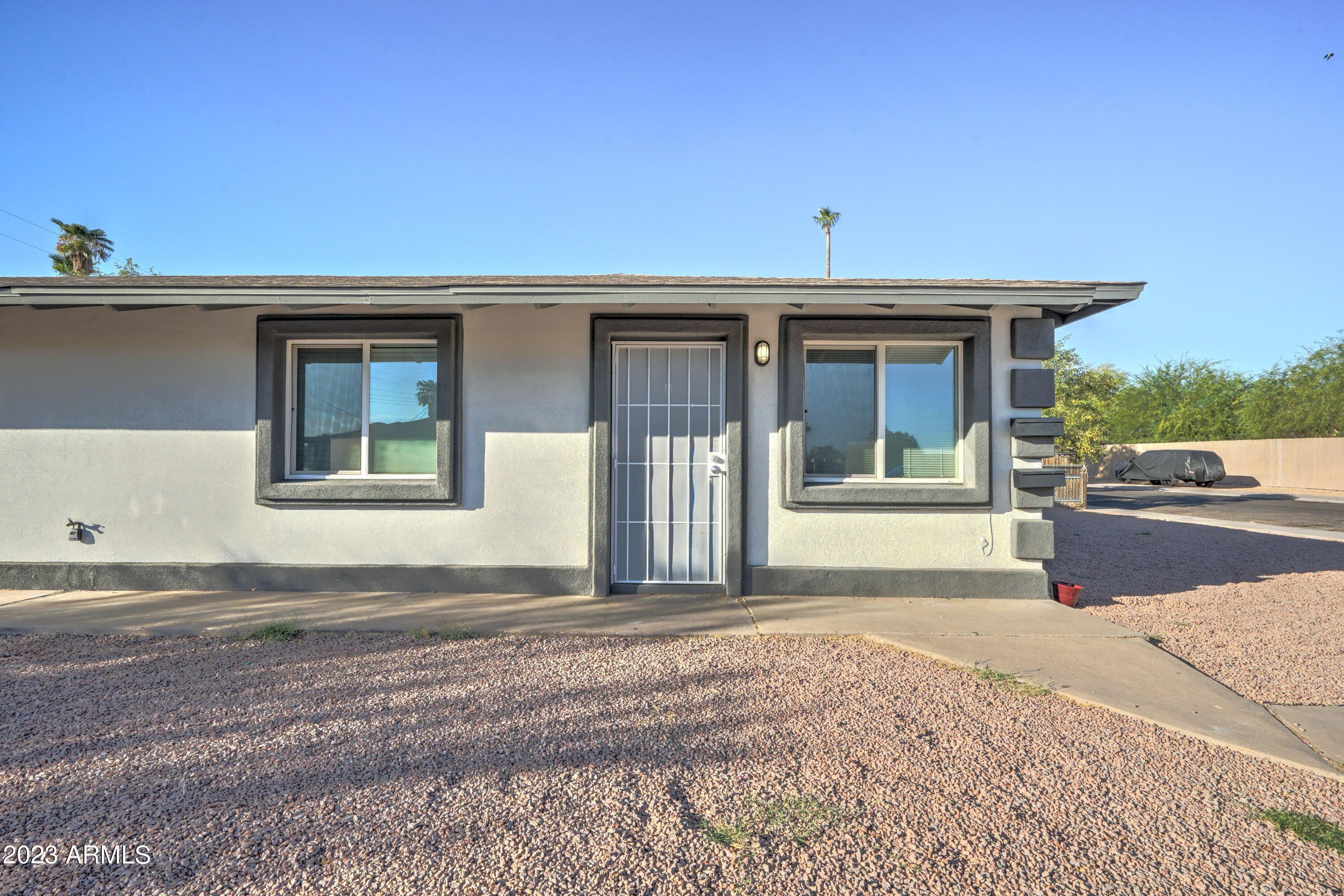 1202 North 49th Place, Unit A Phoenix, AZ 85008 - Photo 2 of 14 a front view of a house with a outdoor space