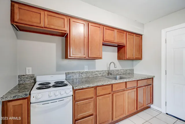 a kitchen with stainless steel appliances granite countertop a sink stove and cabinets